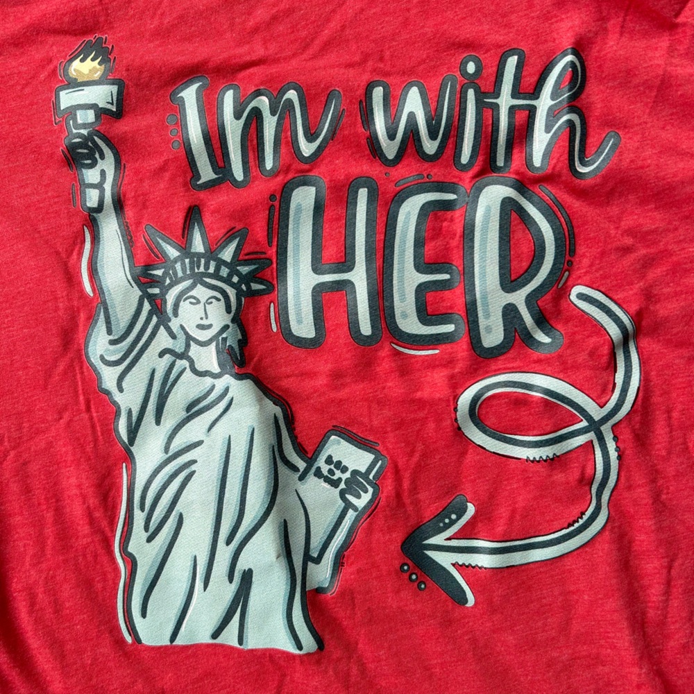 Women’s medium T-shirt with statue of liberty and an arrow stating I’m with her.